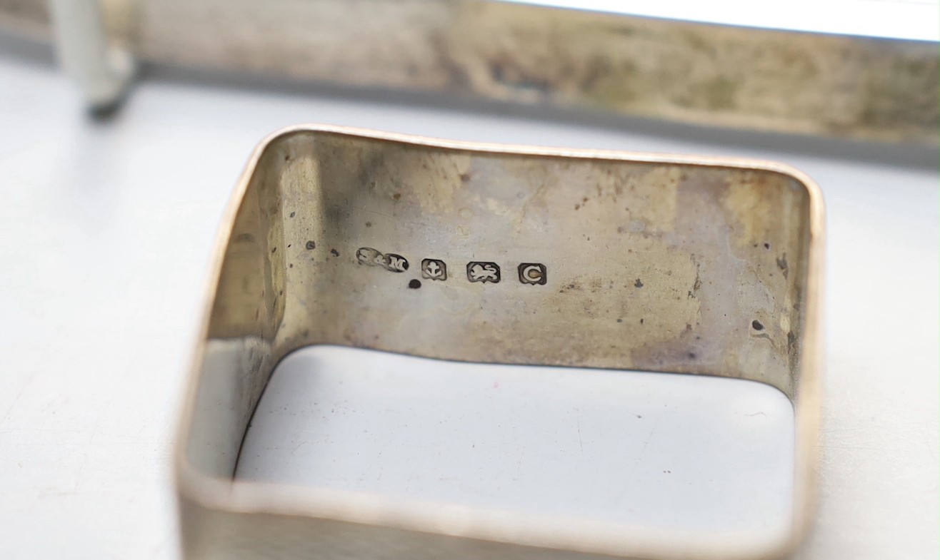 A George V small square silver dish by James Dixon & Sons and three silver napkin rings.